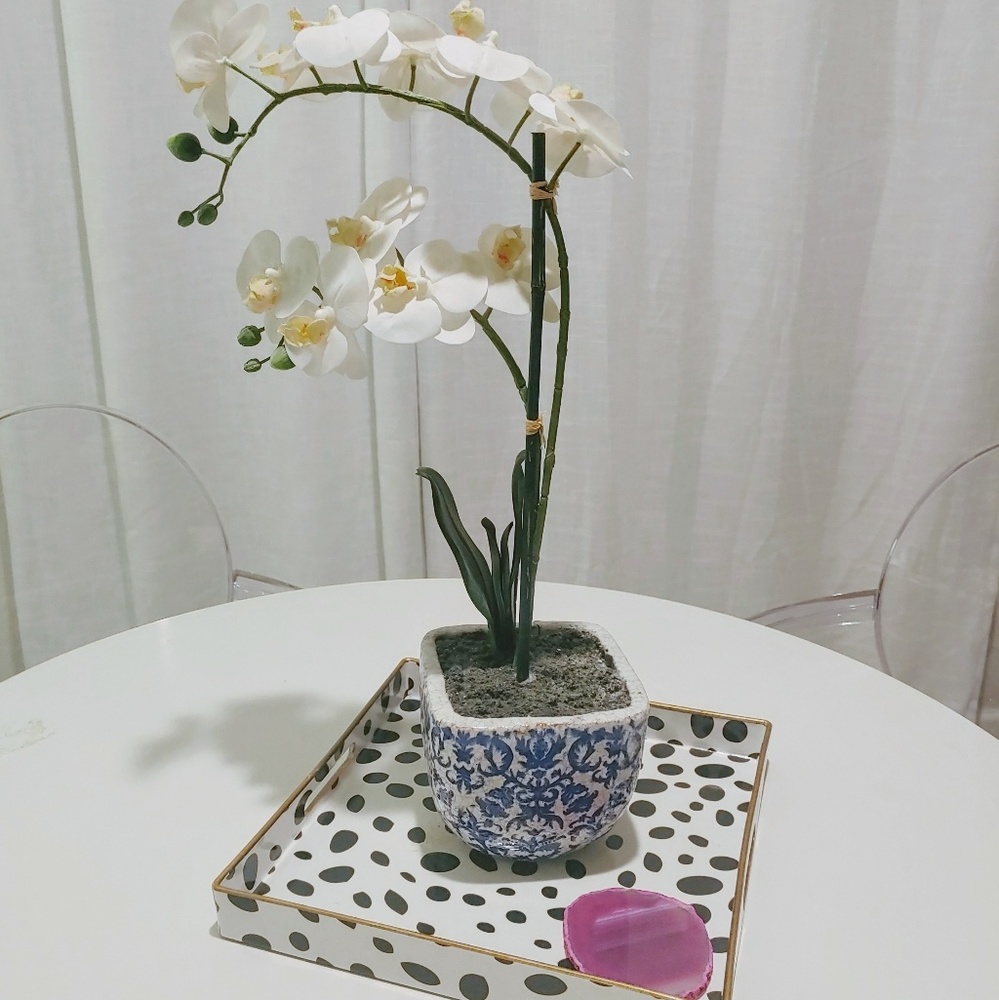 Faux orchid in blue and white pot